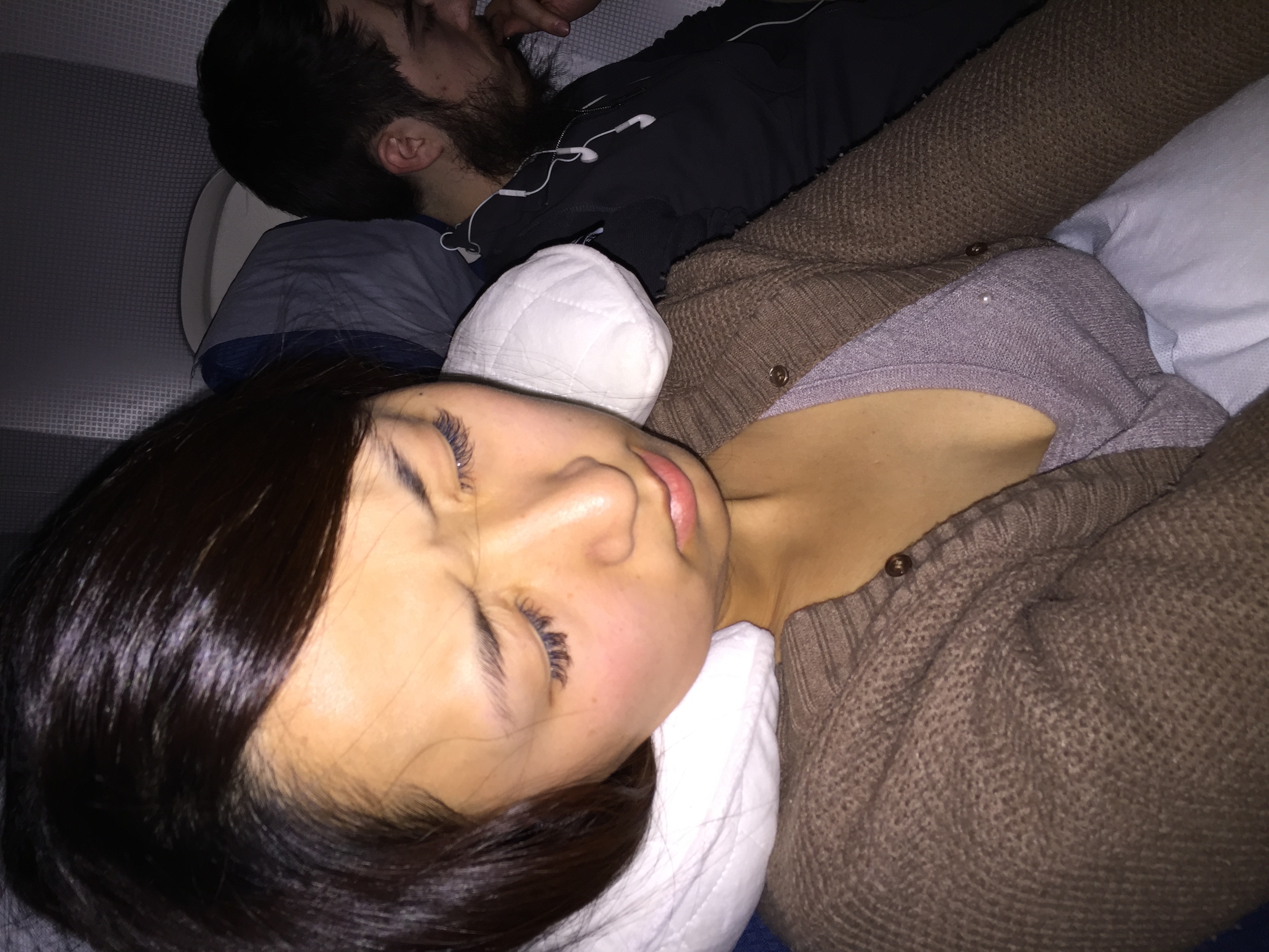 Akiko trying to sleep on the airplane