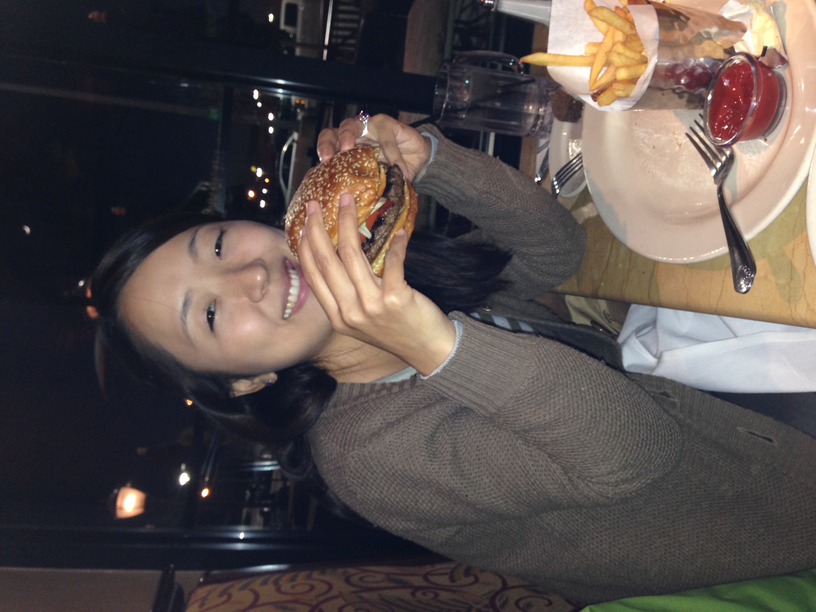 Akiko eating a Texas style burger at The Cheesecake Factory